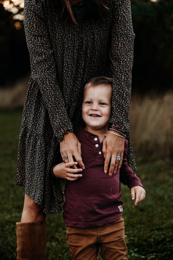 Family Photographer, a mother's hands wrap around her smiling boy
