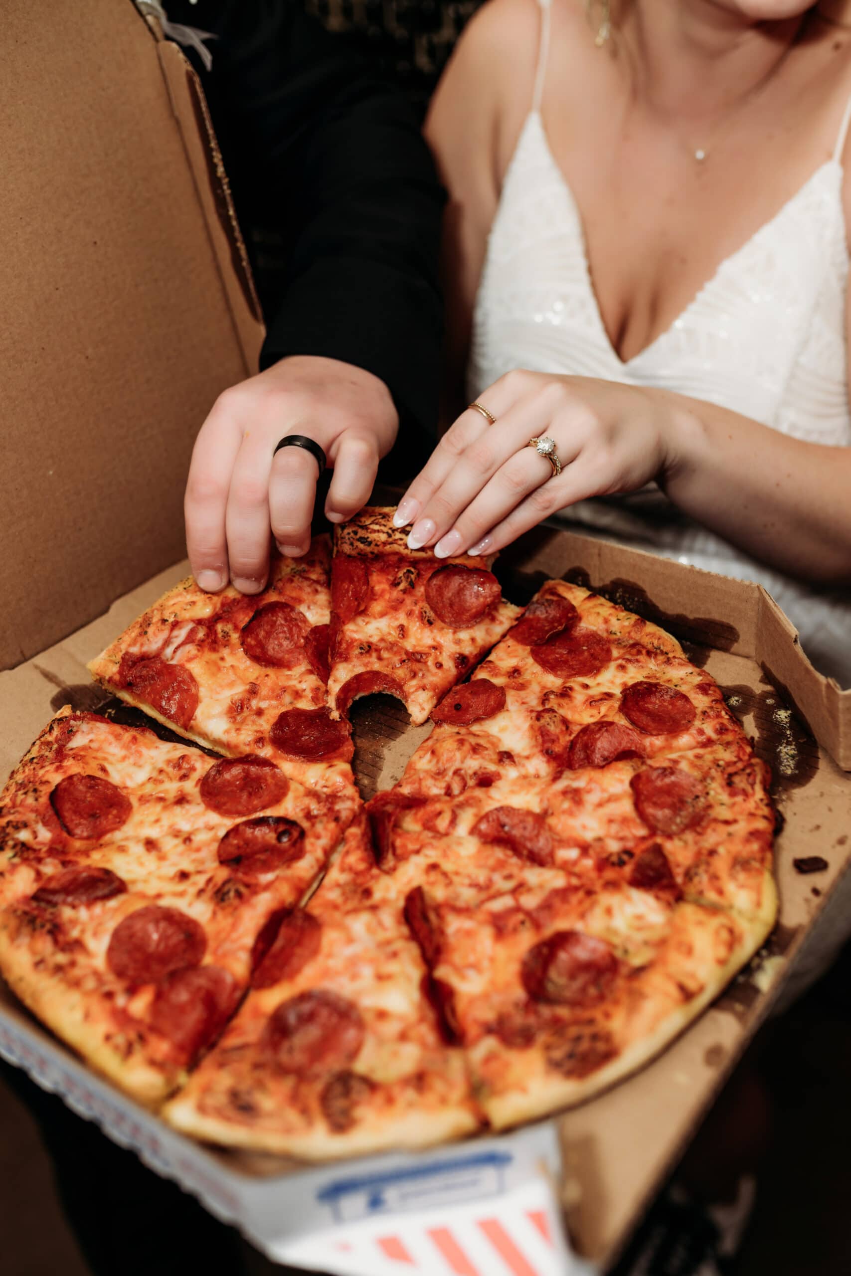 Wedding & Elopement Photography,  bride and groom grabbing a slice of pizza