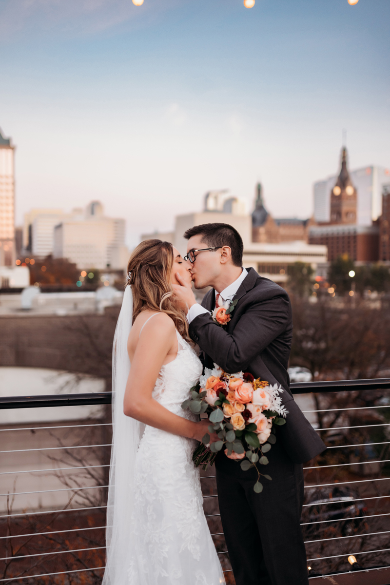 Wedding & Elopement Photography, couple kissing on top of building