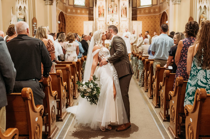 Wedding & Elopement Photography, bride and groom taking a kiss on the church aisle