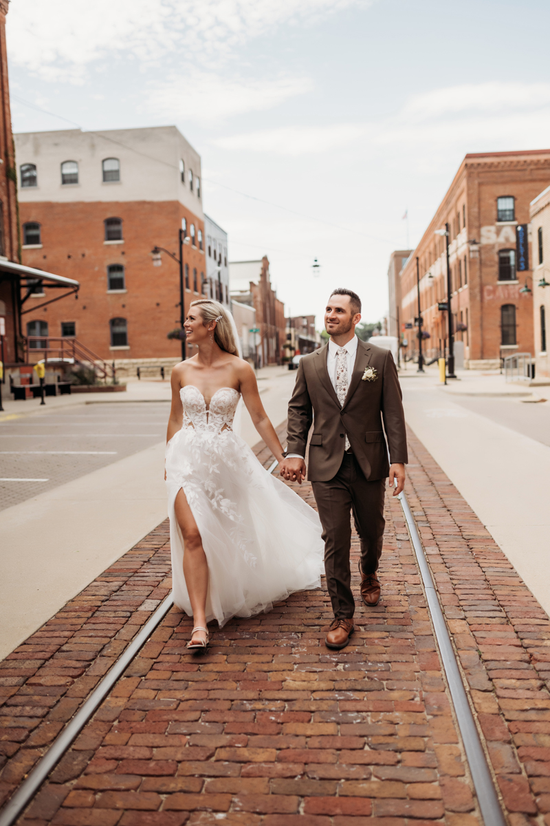 Wedding & Elopement Photography, bride and groom walking down trolley tracks together