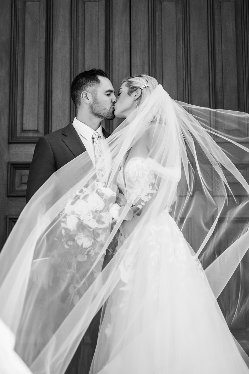 Wedding & Elopement Photography, black and white image of bride and groom kissing