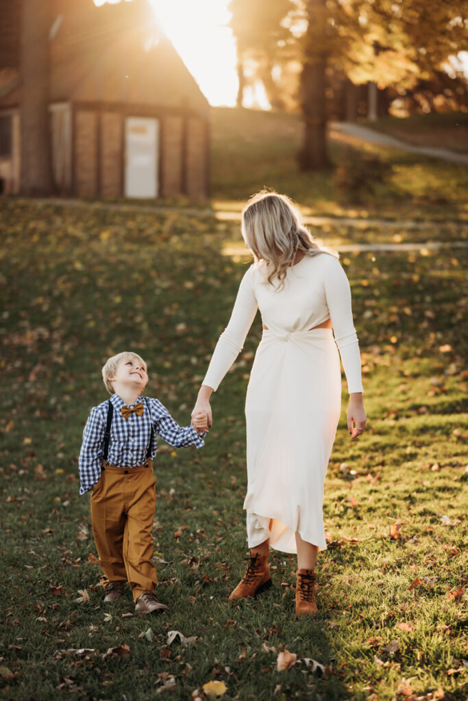 Family & Newborn Photographer, mother and young son walking in the grass, playing together