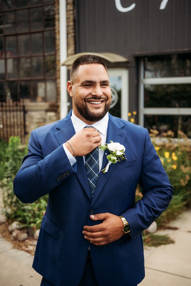 Wedding & Elopement Photography, shot of groom in  blue suit smiling at camera
