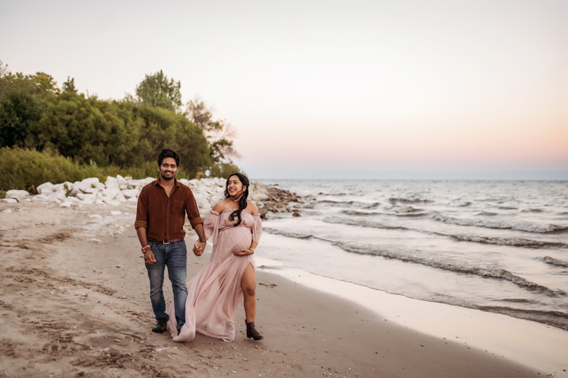 Family & Newborn Photographer, man and pregnant woman walking next to water together