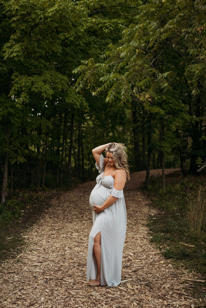 Family & Newborn Photographer, Pregnant woman standing on dirt road with her hand in her hair