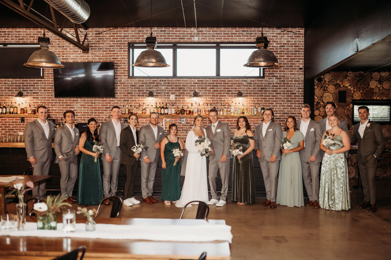Wedding & Elopement Photography, Bridal party lined up against a brick wall at the reception