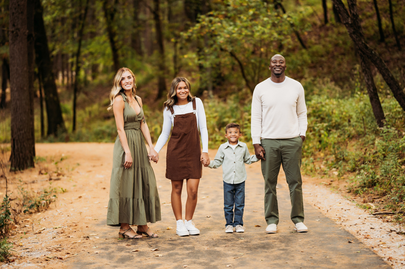 Family & Newborn Photographer, family of four standing on dirt road looking toward the camera